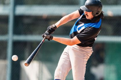 A baseball player hitting the ball